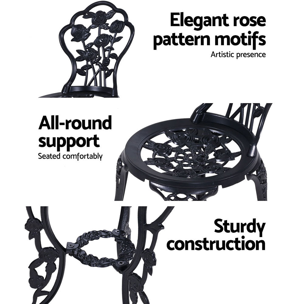 Black bistro chairs with ornate rose motifs and a matching round pedestal table