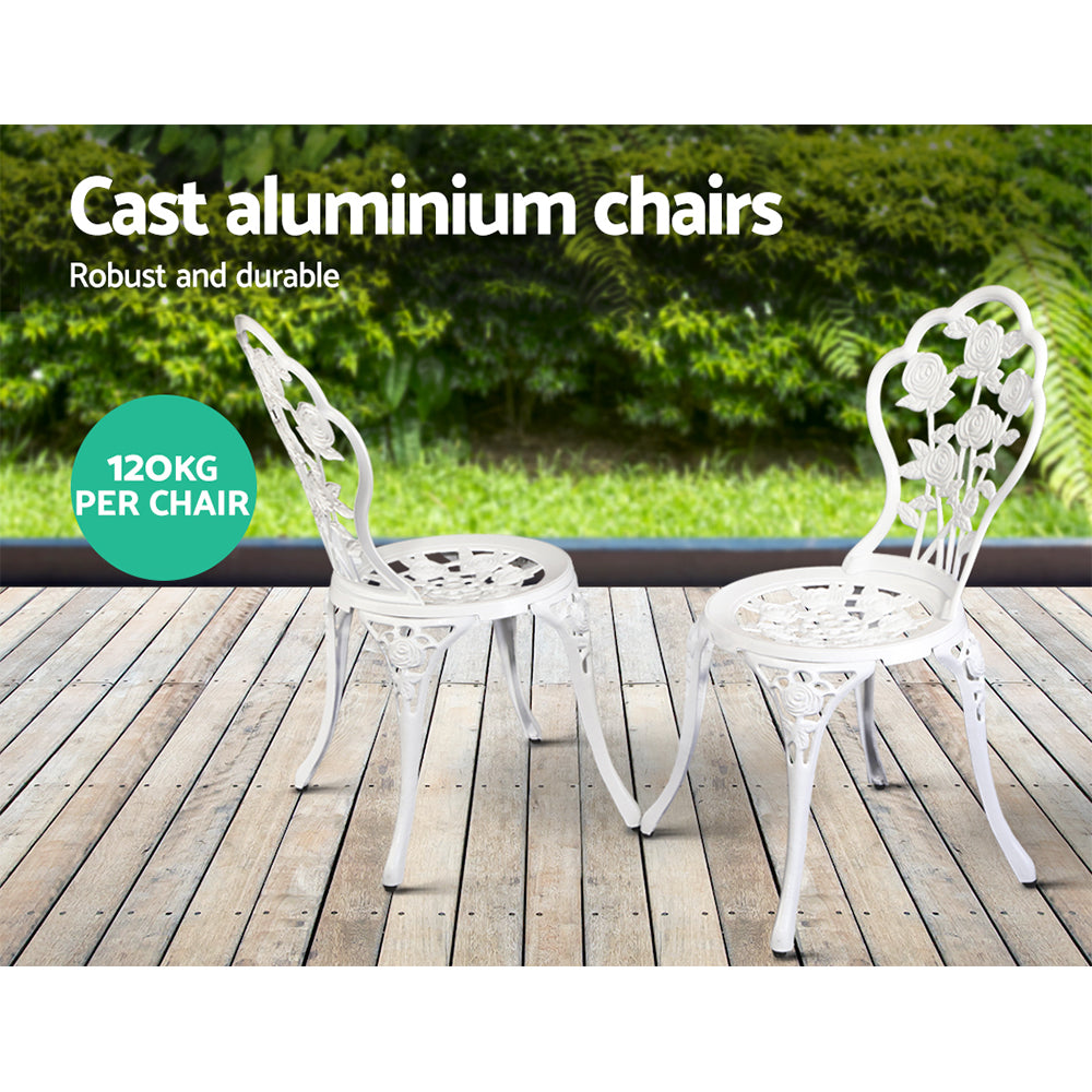 White cast-aluminum bistro chairs with matching round table on outdoor deck