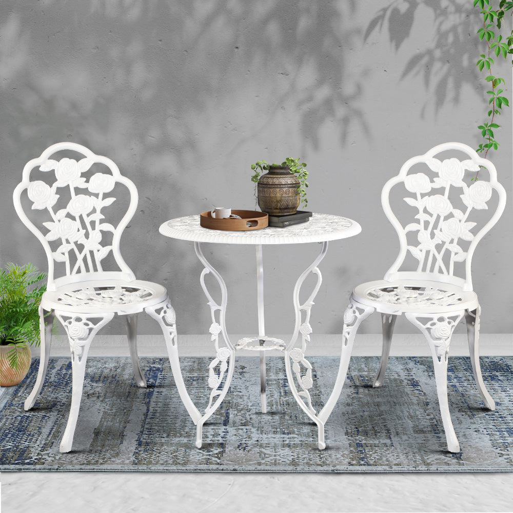 White cast-aluminum bistro set with two ornate chairs and round table