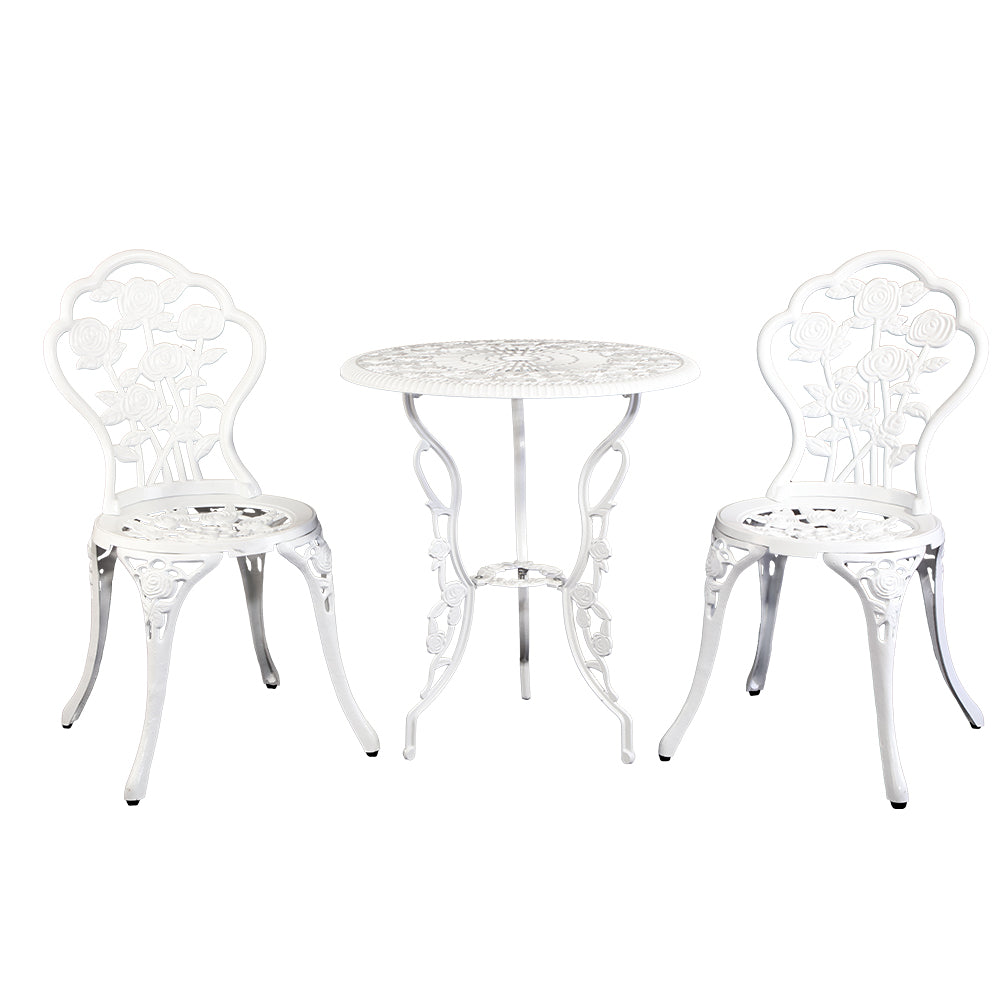 White cast-aluminum bistro table with two matching ornate chairs