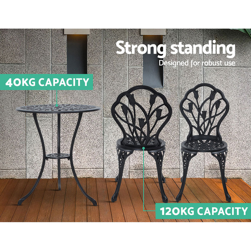 Black bistro table and two chairs with ornate tulip backs and sturdy legs