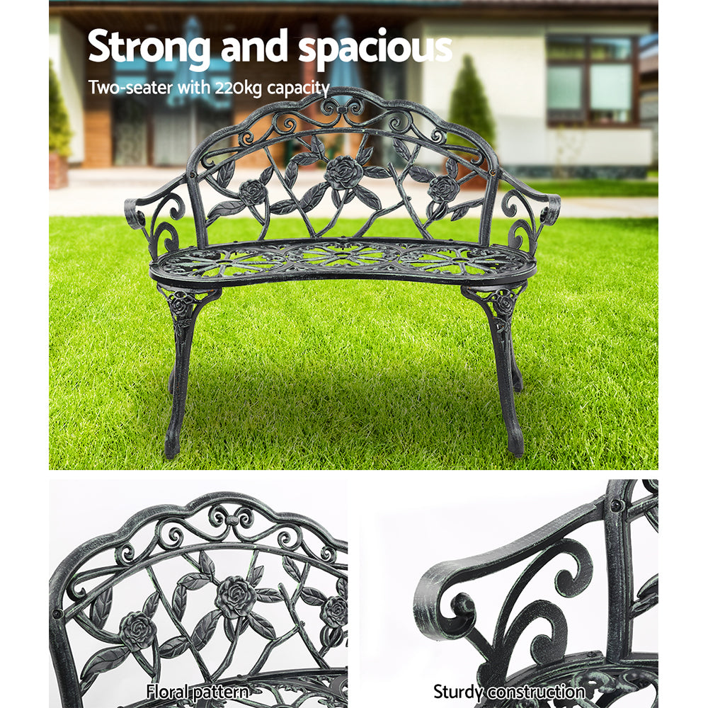 Cast aluminum garden bench seat, floral wrought-style back and dark legs, green details