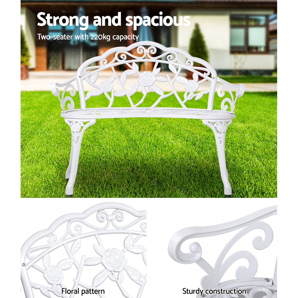 Vintage white cast aluminum bench chair with floral lattice back and decorative posts