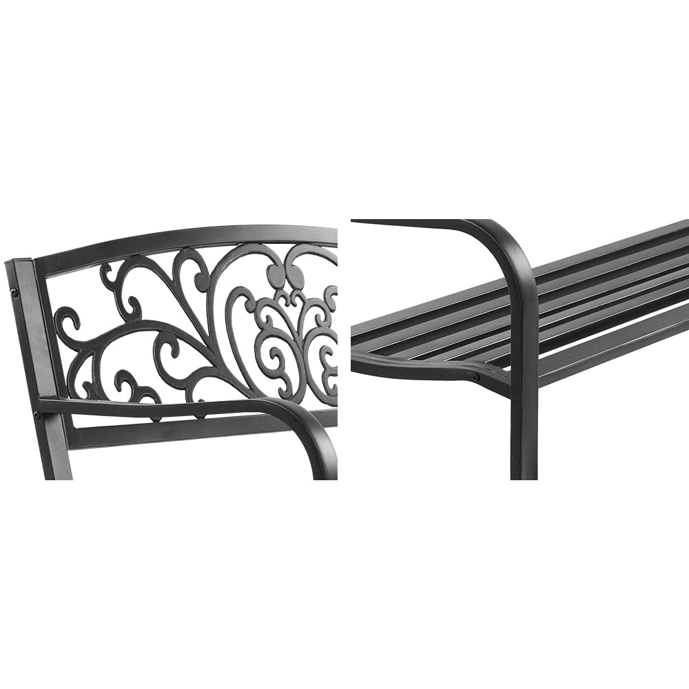 Black metal outdoor bench arm detail with scroll back panel and slatted seat