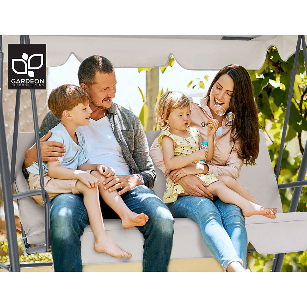 Beige canopy swing chair with padded seat and backrest, family seated