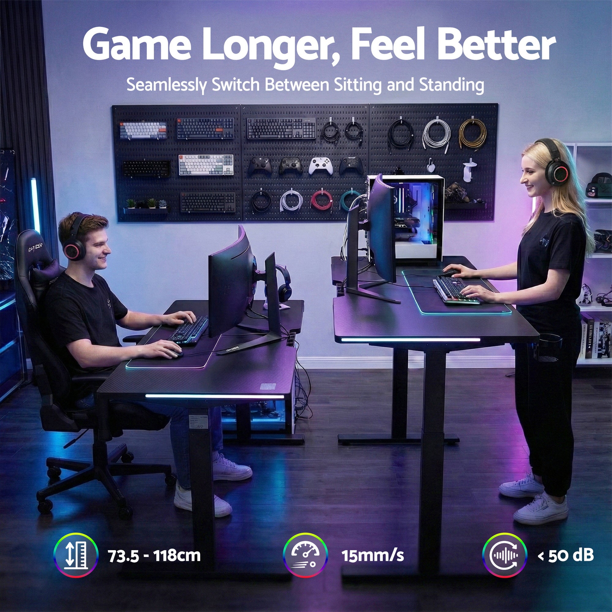 Black electric standing desk with gaming monitors, keyboards, and RGB-lit desktop edges