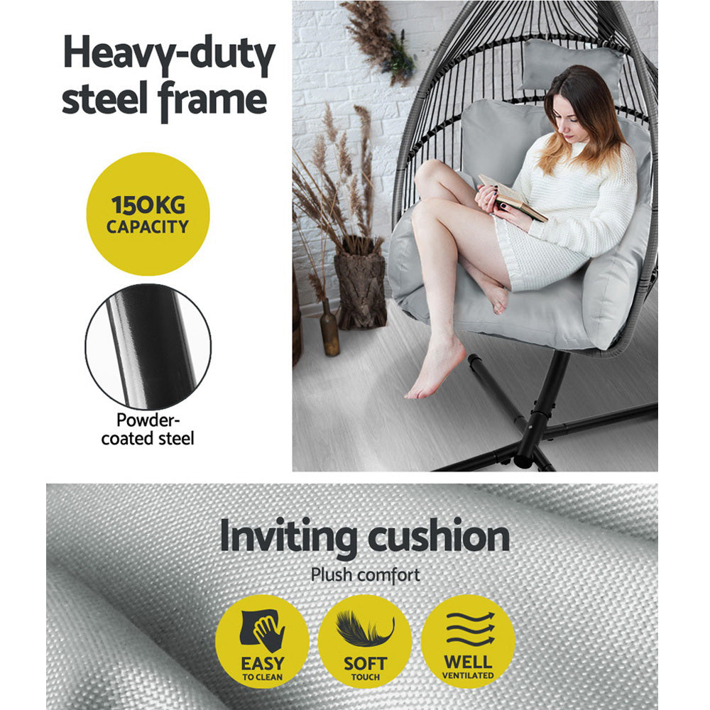 Egg swing chair with grey plush cushions and black steel frame