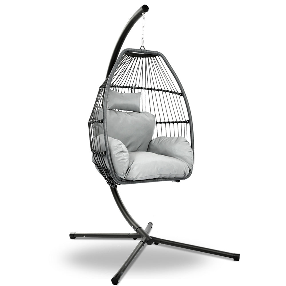 Hanging egg swing chair with black stand and grey cushion on oval woven seat