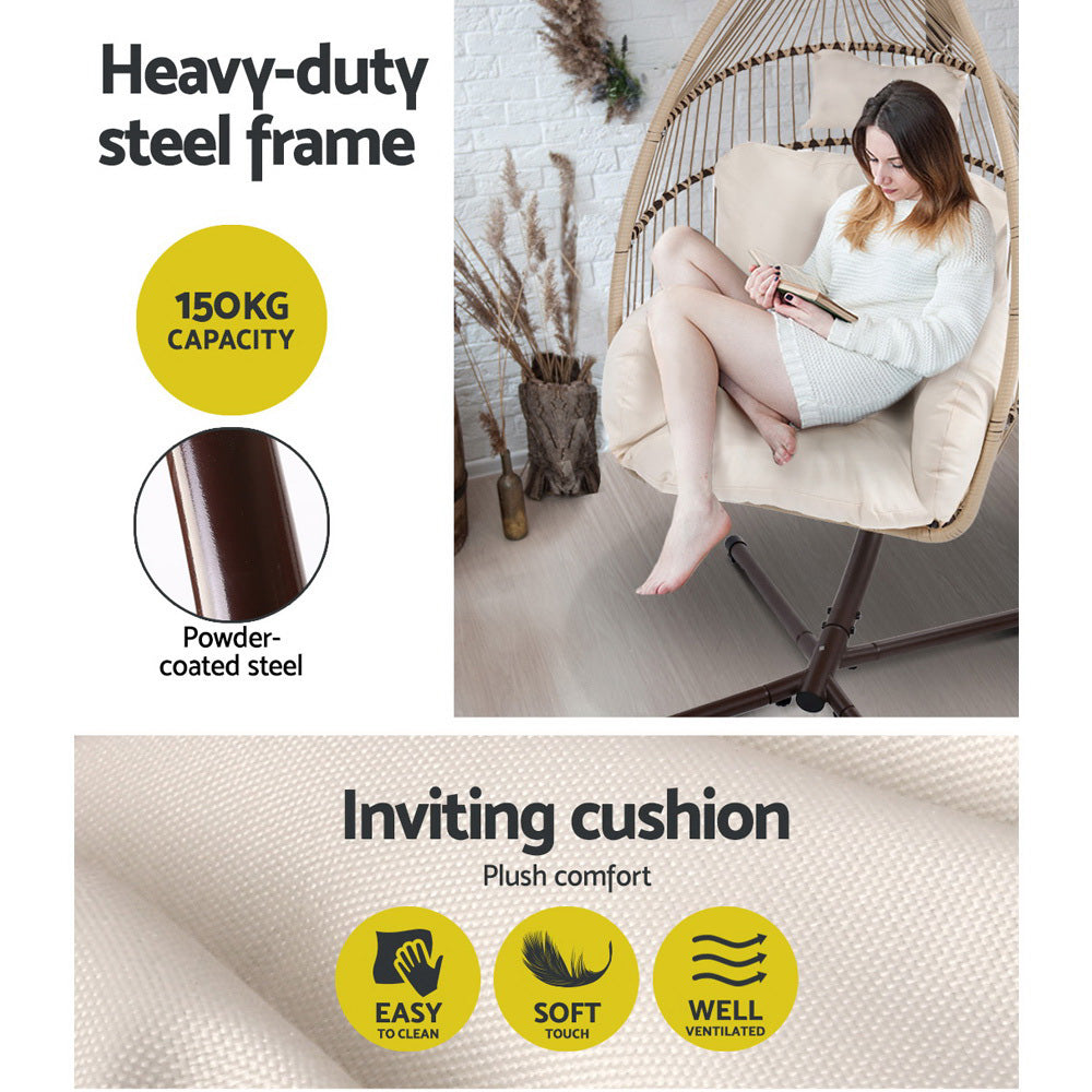 Wicker egg swing chair with beige cushion and dark powder-coated steel frame
