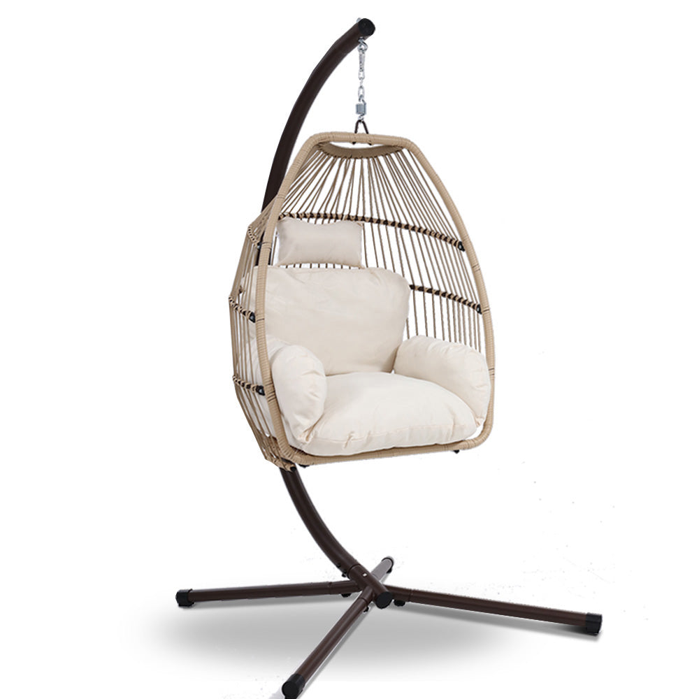Wicker egg swing chair with beige cushion, dark stand base, and hanging chain