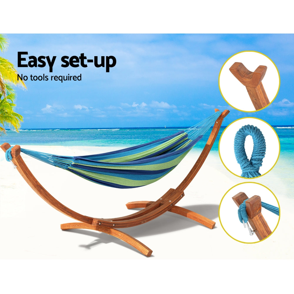 Hammock and wooden stand set with blue rope ties and striped fabric sling