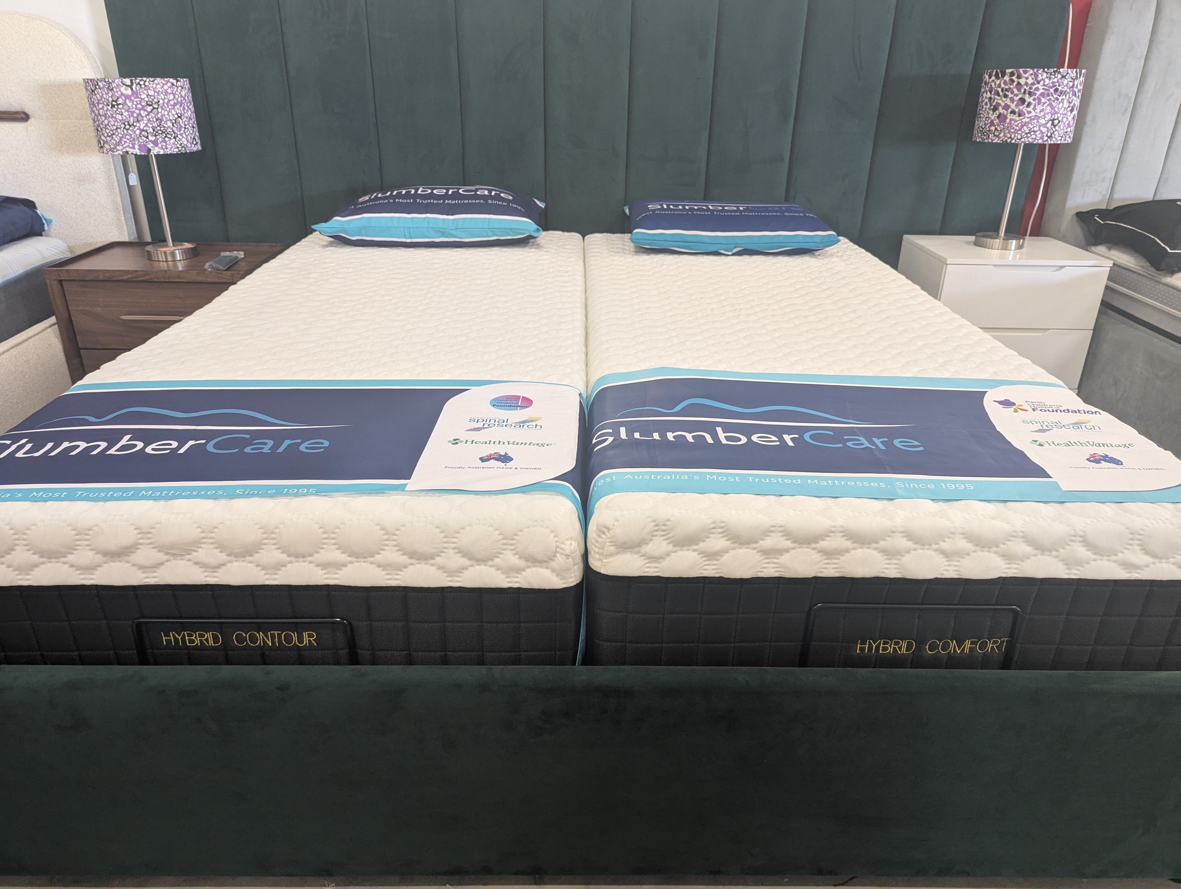 SlumberCare hybrid contour mattress, white quilted top with blue band and dark base.