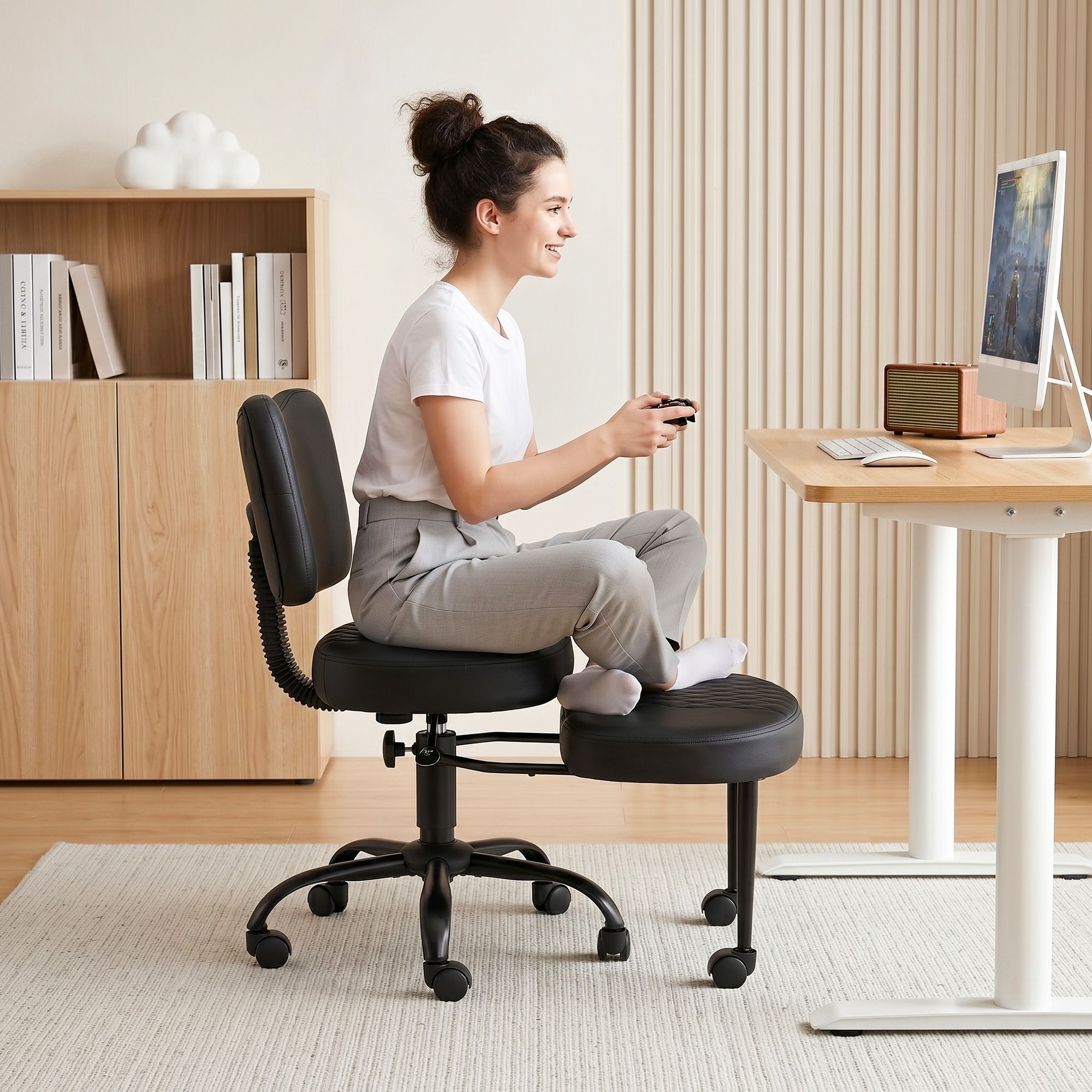 Black kneeling chair with backrest and padded foot platform, rolling casters