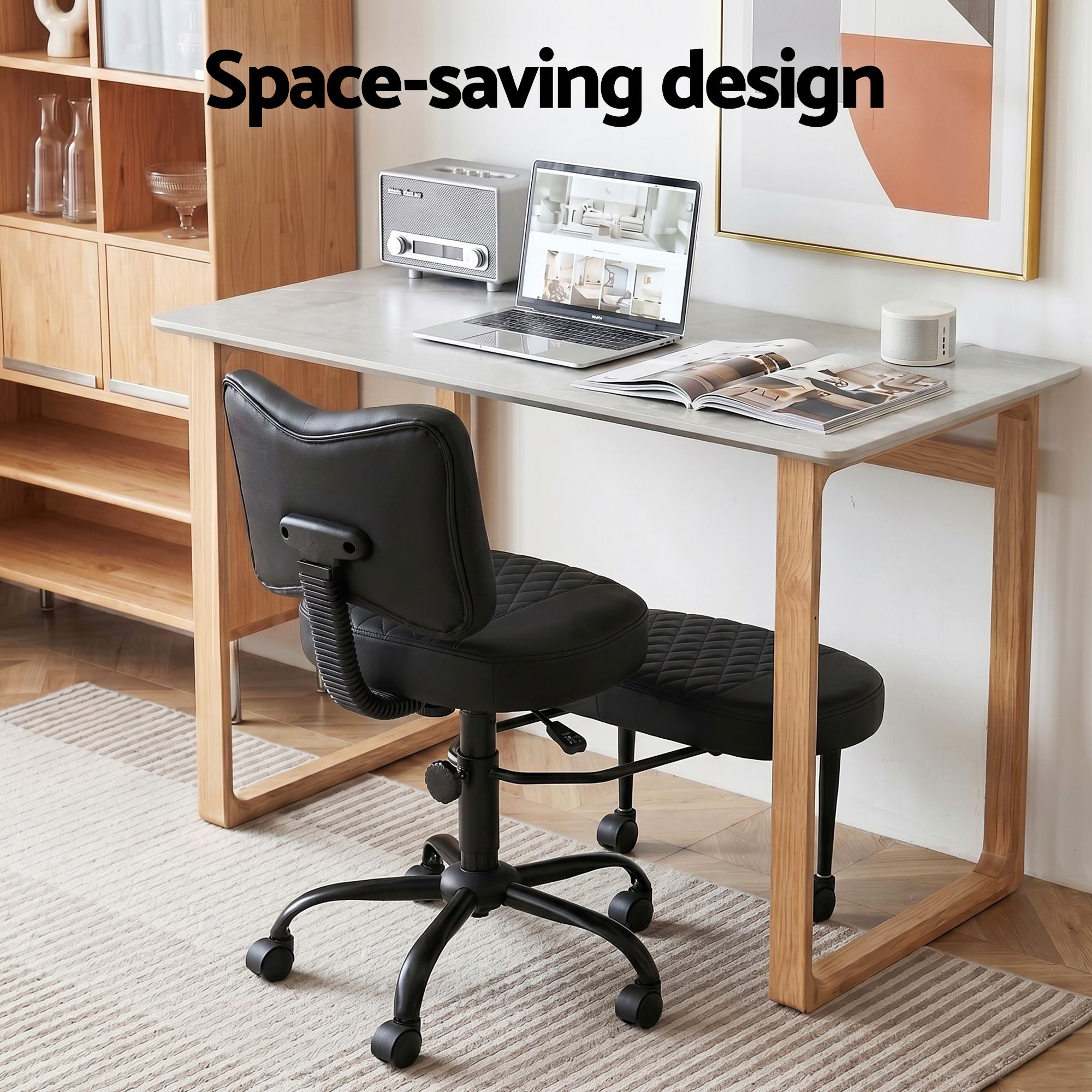 Black cross-legged kneeling chair with padded backrest and quilted seat, rolling base