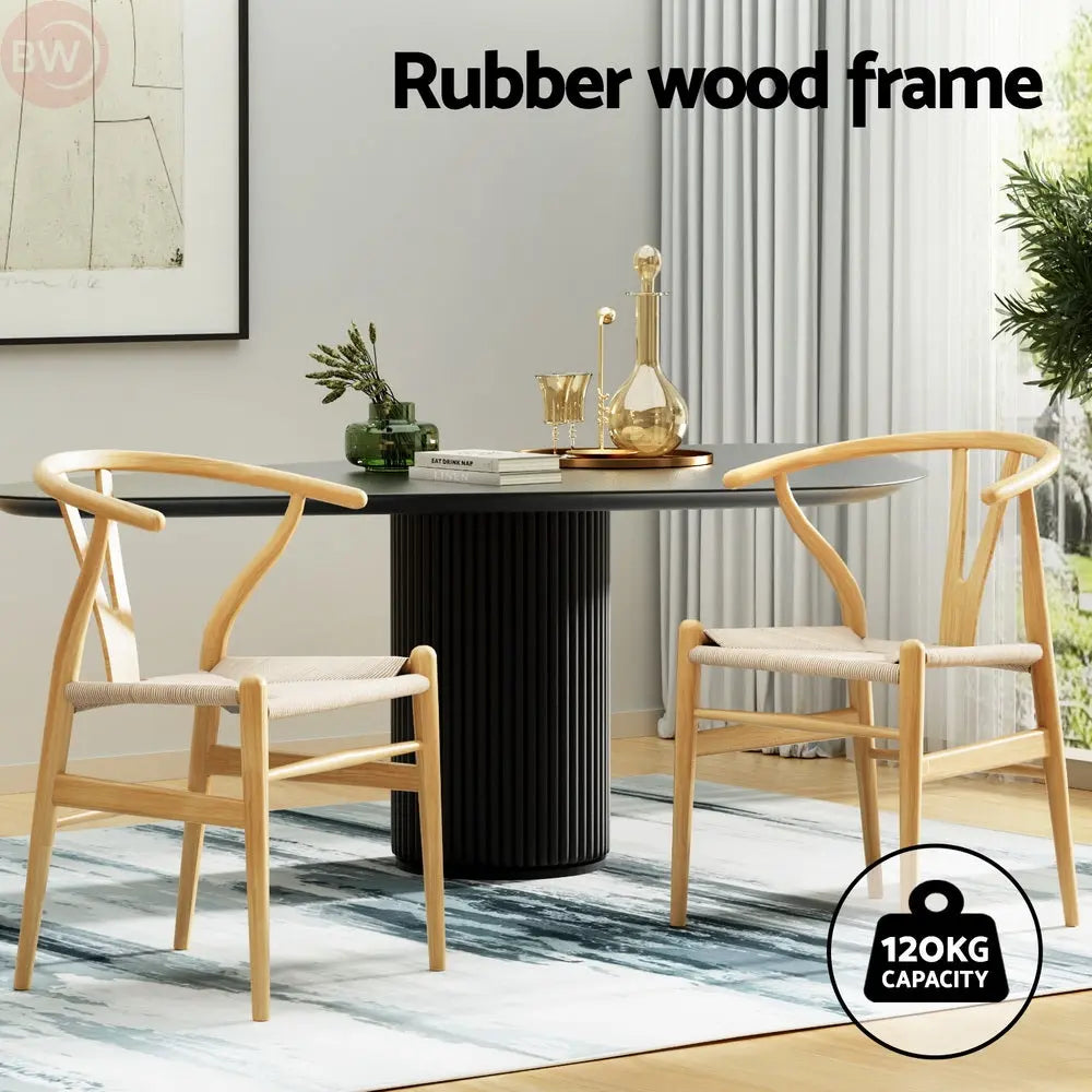 Wood dining chairs with wishbone backs and beige upholstered seats