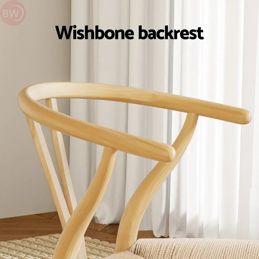 Light wood wishbone chair backrest over beige upholstered seat
