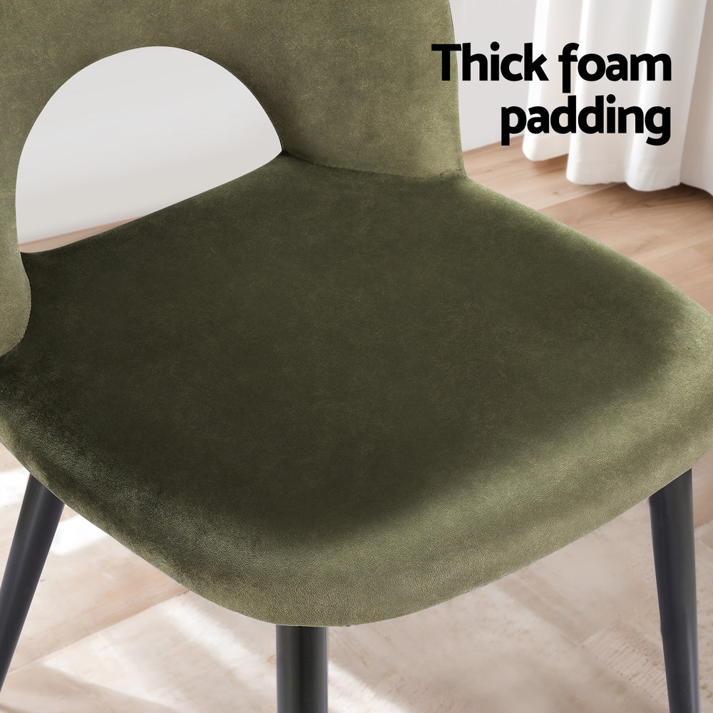 Velvet dining chair seat, olive green thick foam padding and rounded contours, black legs.