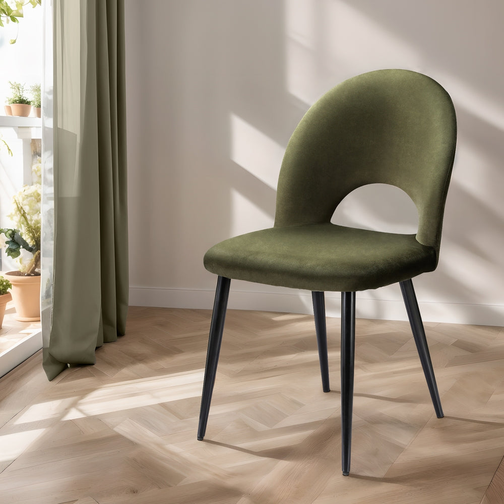 Velvet dining chair, olive green upholstered seat and curved back, black tapered legs.