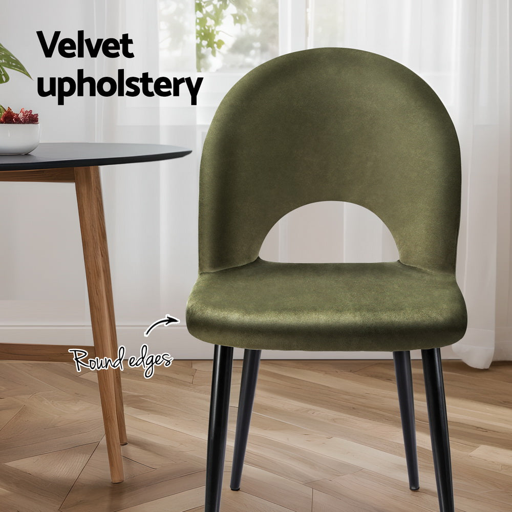 Velvet dining chair in olive green with rounded edges and arched cutout back