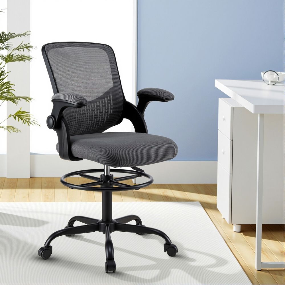 Grey mesh drafting office chair with padded seat, curved backrest, armrests, and caster wheels
