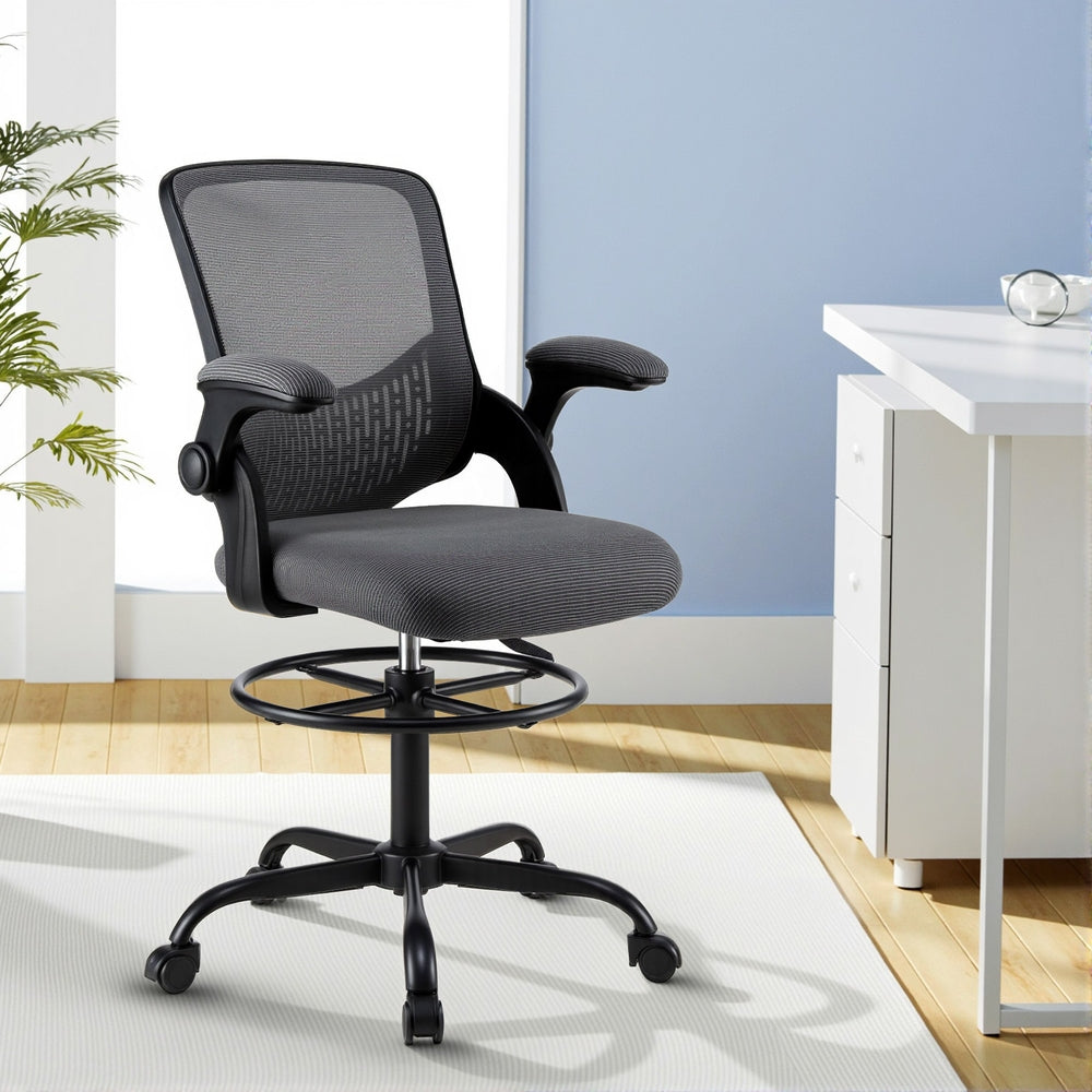 Grey mesh office chair with padded seat, armrests, curved backrest and rolling casters