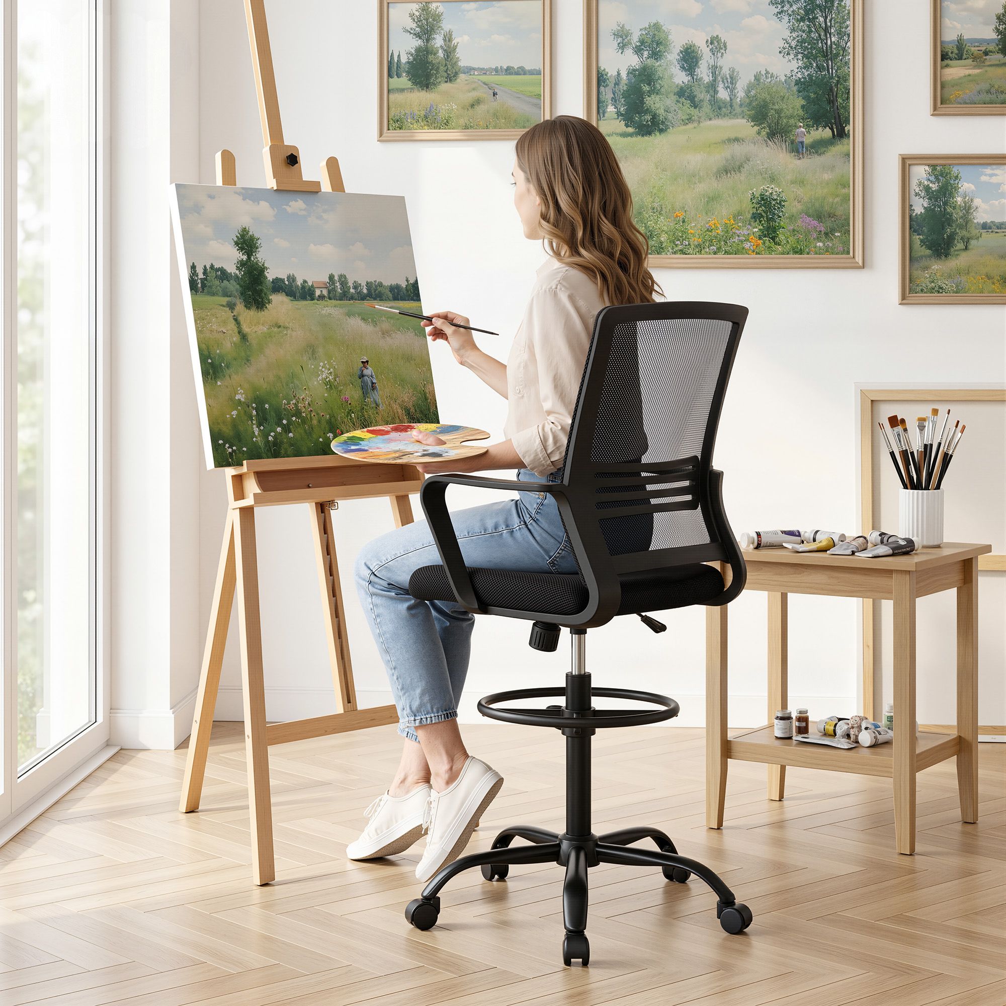 Black mesh drafting chair with cushioned seat, height-adjust lift, and rolling base