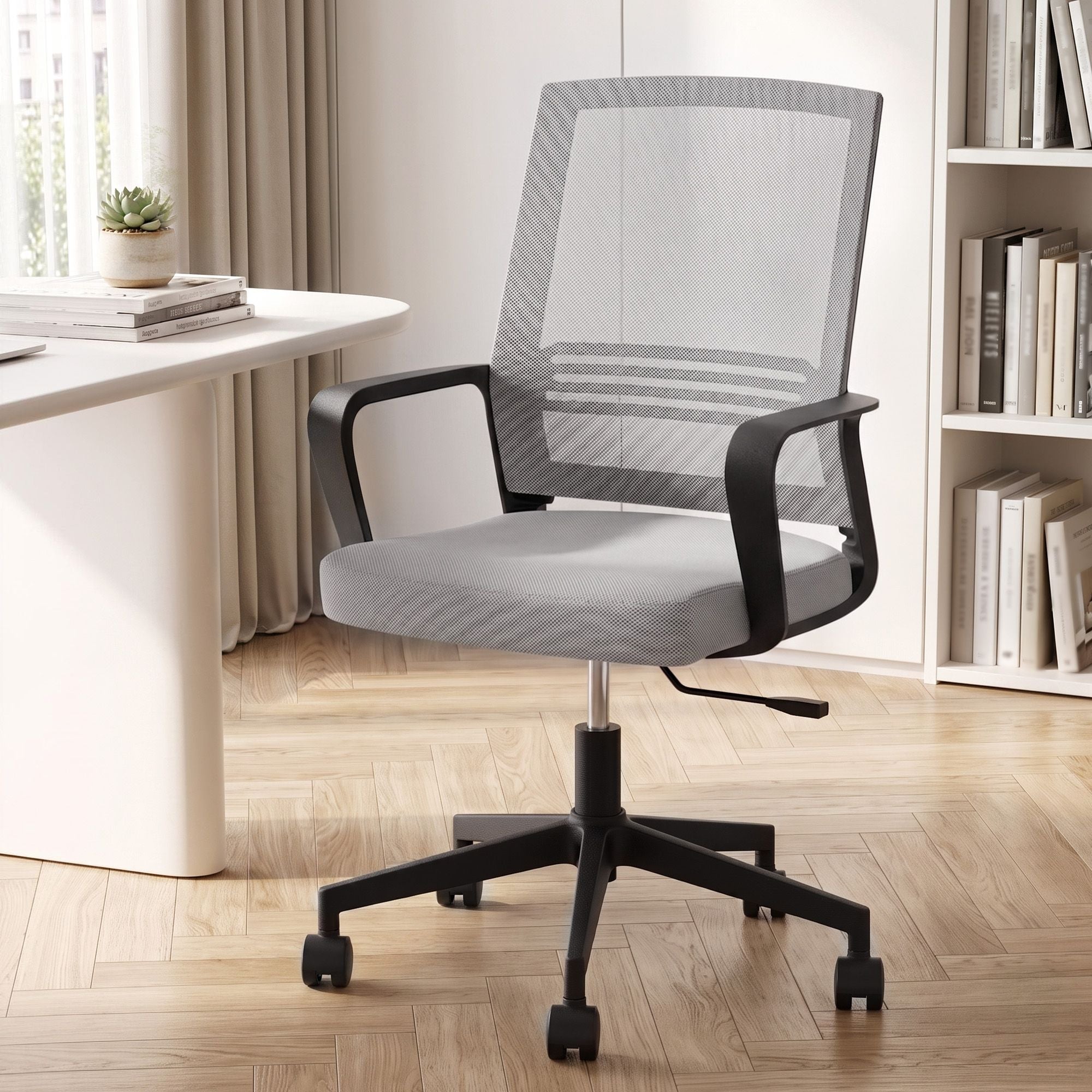 Grey mid-back mesh office chair with armrests, padded seat, and black swivel caster base