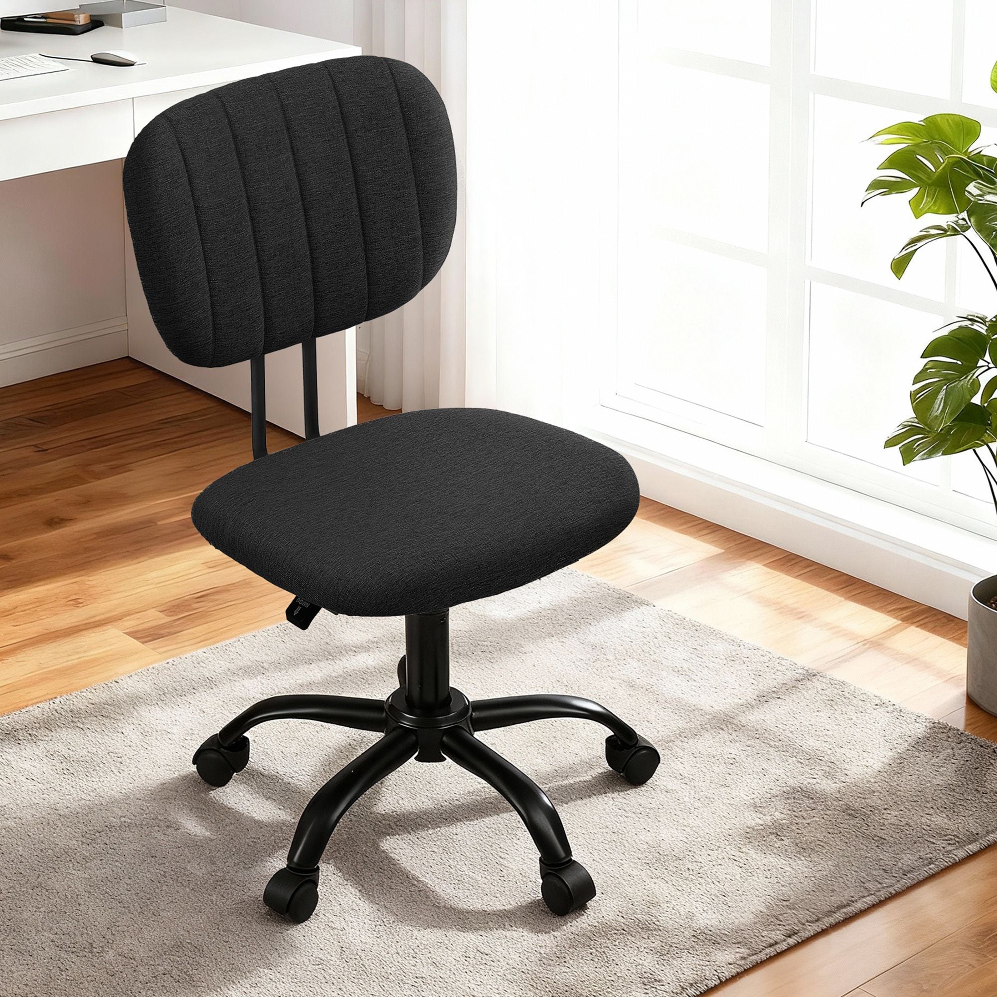 Black armless office chair with padded fabric seat and backrest, swivel base with casters