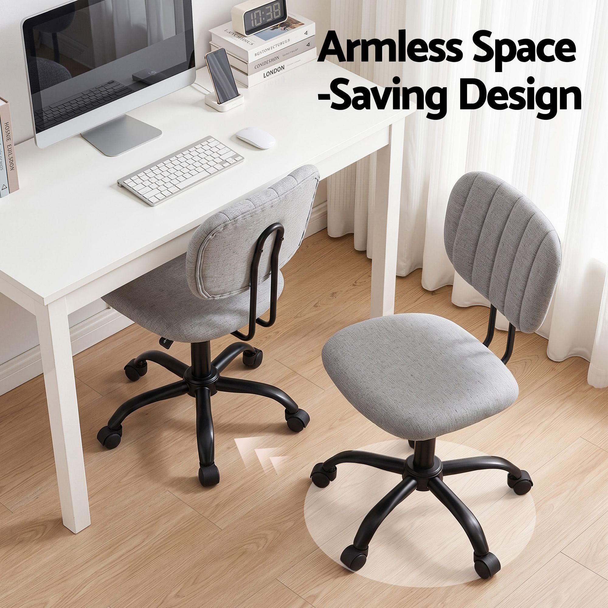 Grey armless office chair with fabric seat and back, rounded base on rolling casters