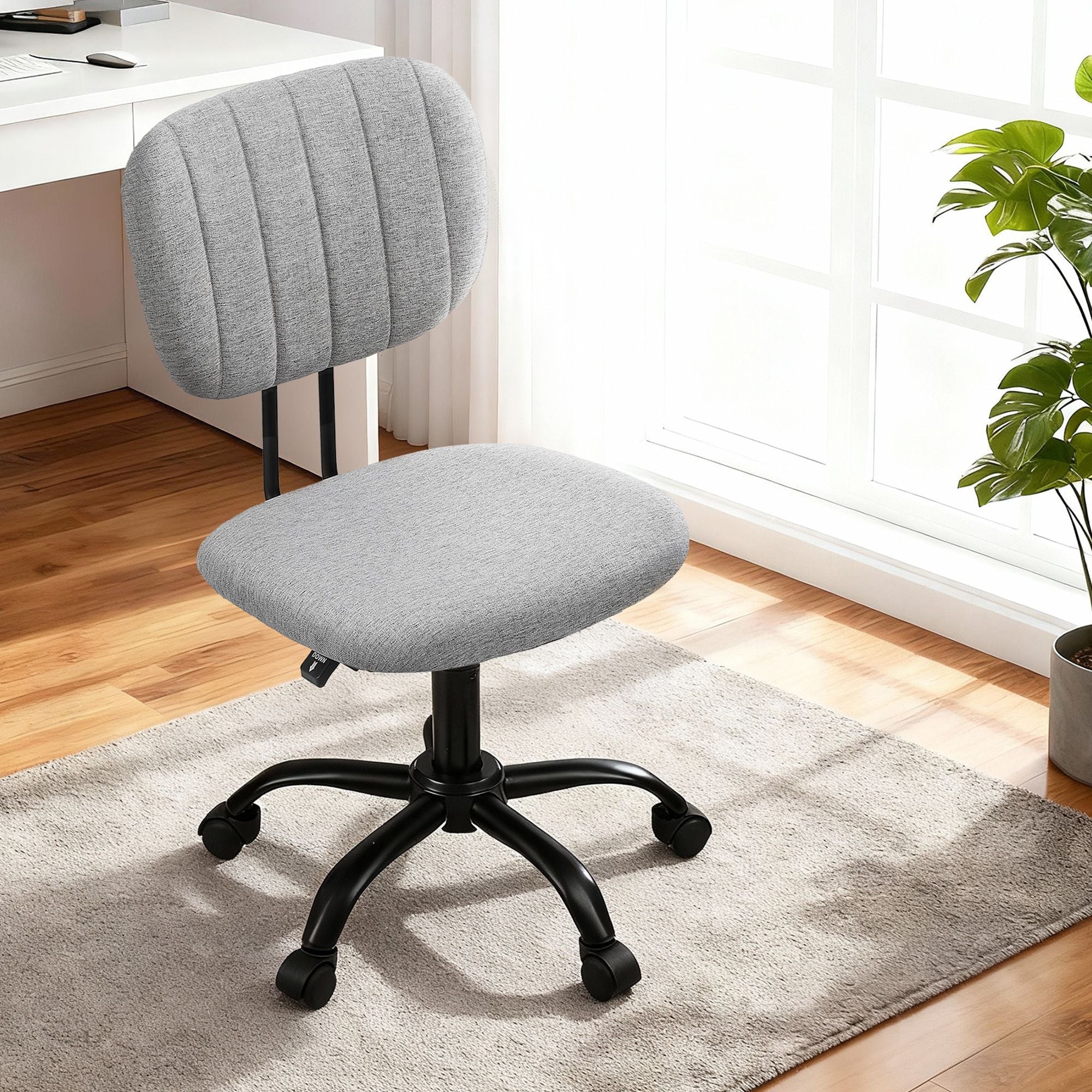 Grey fabric armless office chair with swivel base, caster wheels, and padded seat