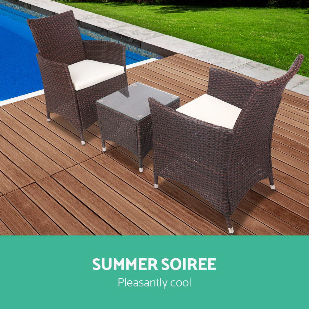 Dark brown wicker bistro set with two chairs, white cushions, and glass-top table