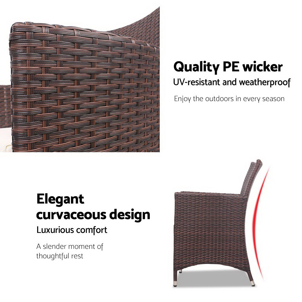 Dark brown wicker patio chair with white seat cushion, curved back design
