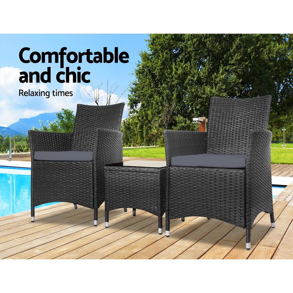 Outdoor bistro chair set: dark woven armchairs with gray cushions and a small table