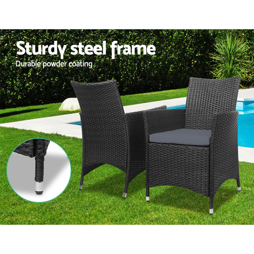 Dark woven patio armchairs with gray seat cushions and sturdy metal legs