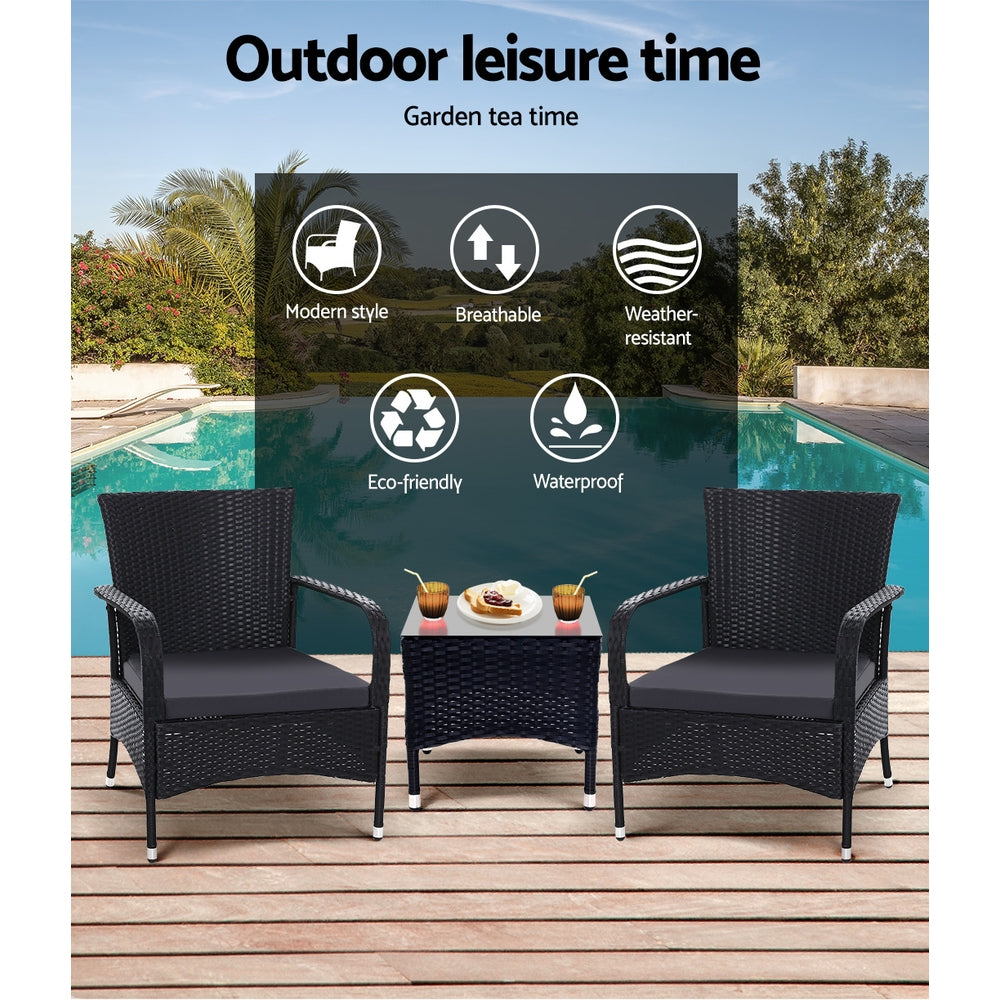 Outdoor bistro set on deck: two black wicker armchairs with padded seats and side table