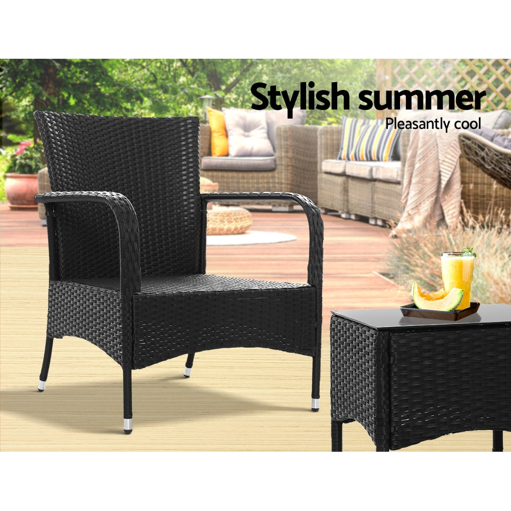 Outdoor bistro set with black wicker armchair and small side table with glass top