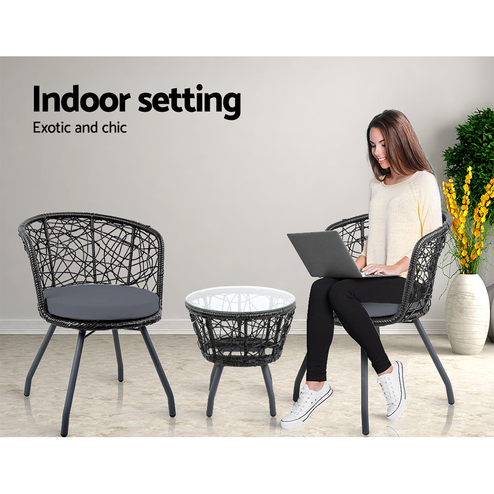 Bistro seating set with two black woven chairs, gray cushions, and round side table