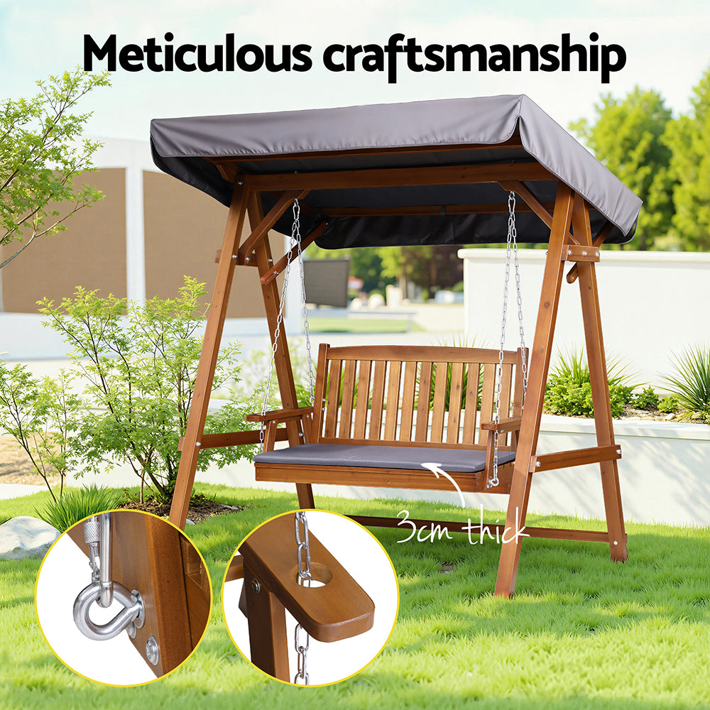 Outdoor wooden swing bench with canopy and dark gray seat cushion, shown with chain details