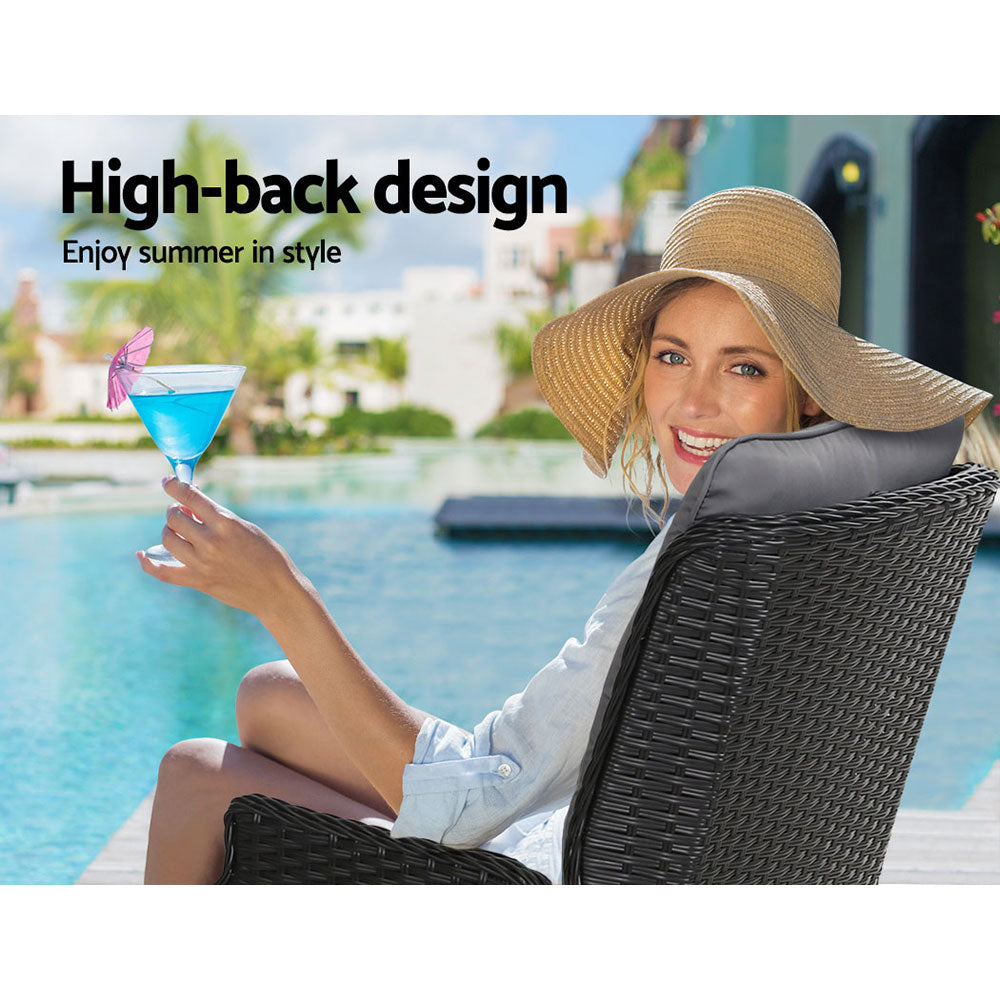 High-back outdoor wicker recliner chair with dark weave and light gray padded backrest