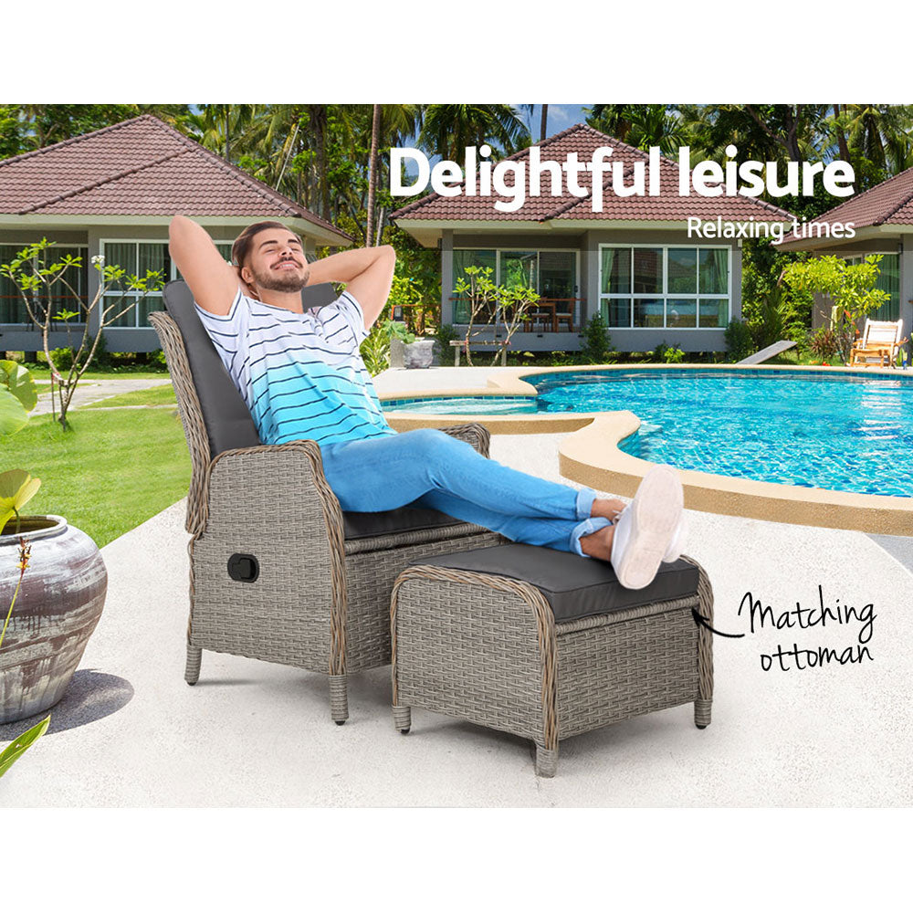 Outdoor reclining wicker chair with grey cushions, reclining back, and matching ottoman