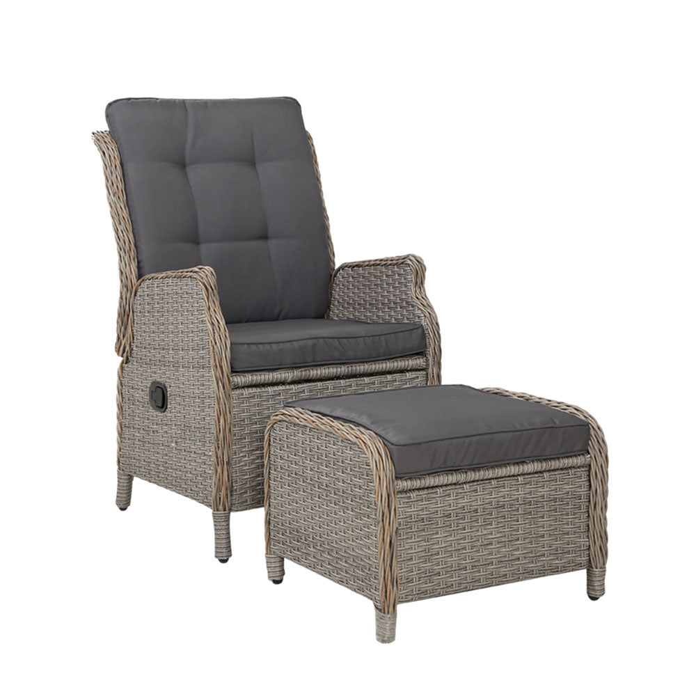 Outdoor wicker recliner chair with grey padded backrest and ottoman footrest
