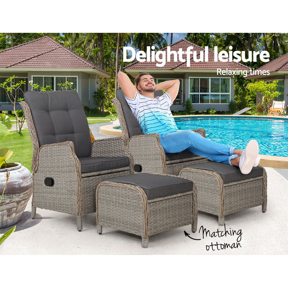 Outdoor recliner chair with dark grey cushions and woven wicker frame, matching ottoman
