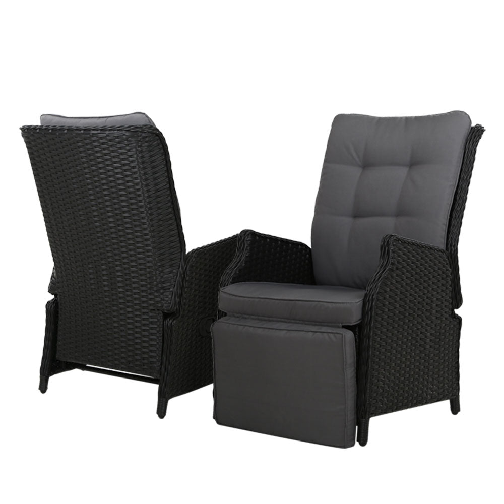 Outdoor recliner lounge chair pair with black wicker and gray padded seats and backrests