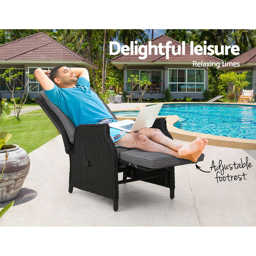 Outdoor recliner lounge chair with black wicker and gray reclining cushion, extended footrest