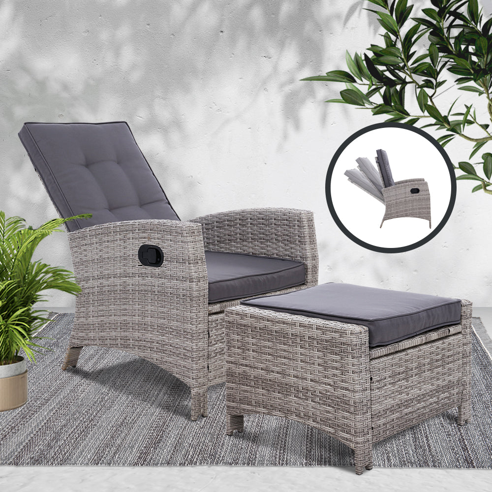 Grey wicker outdoor recliner chair with dark grey cushions and matching ottoman