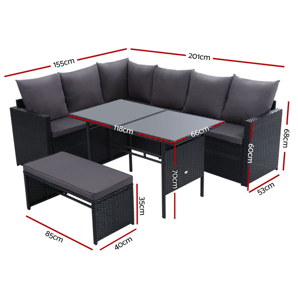Black corner sofa lounge with gray cushions, rectangular glass-top table, and bench