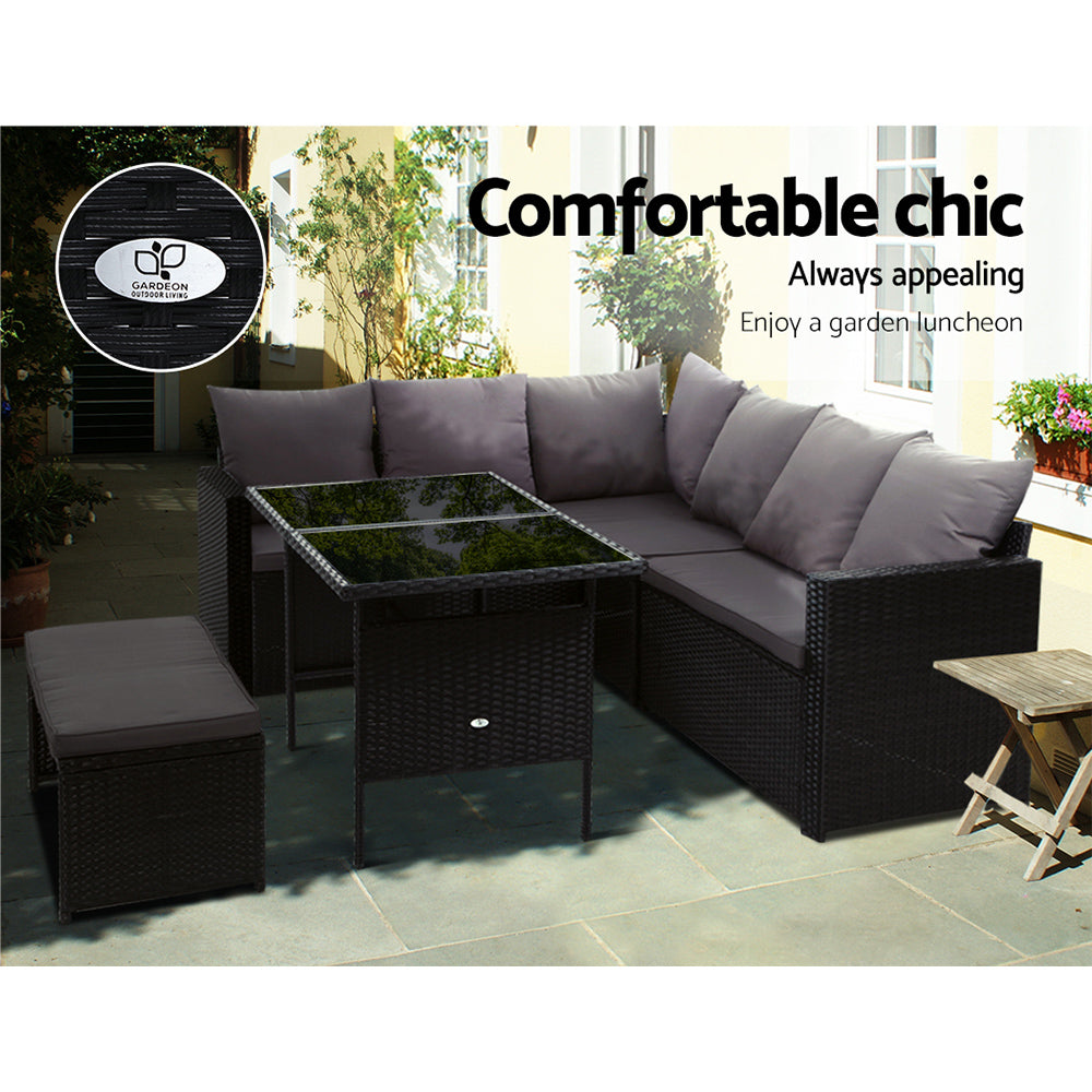 Outdoor patio black wicker sectional sofa lounge with gray cushions and glass-top table