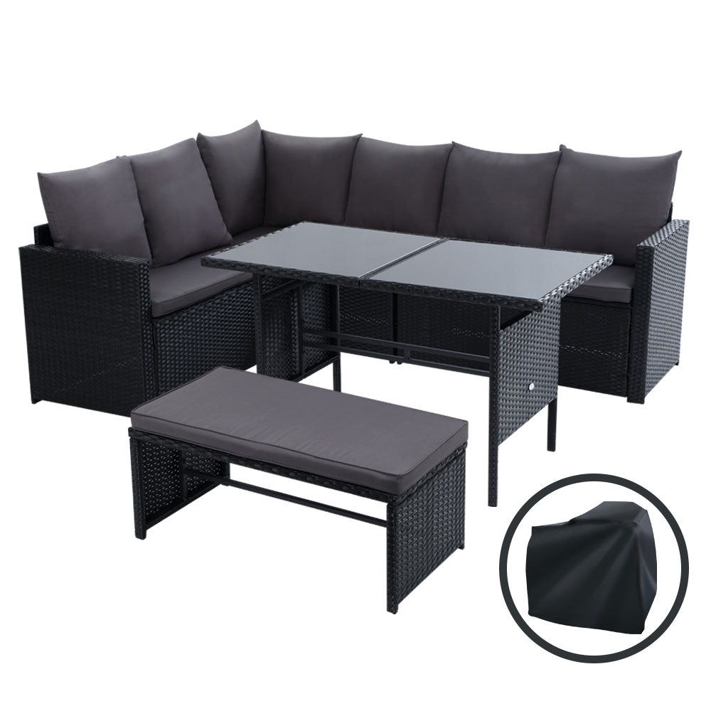 Black wicker outdoor corner sofa lounge with gray cushions, glass-top table, and bench
