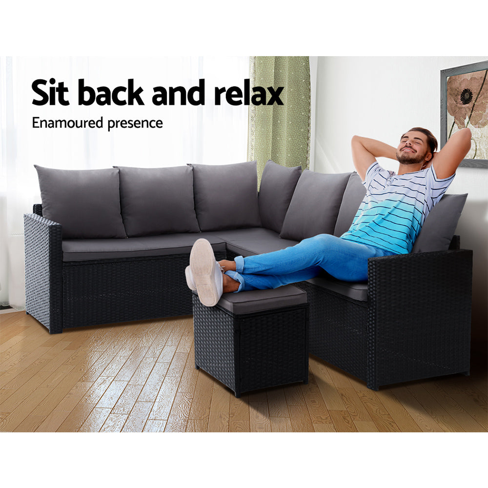Black patio corner sofa set with gray cushions and square ottoman for lounging