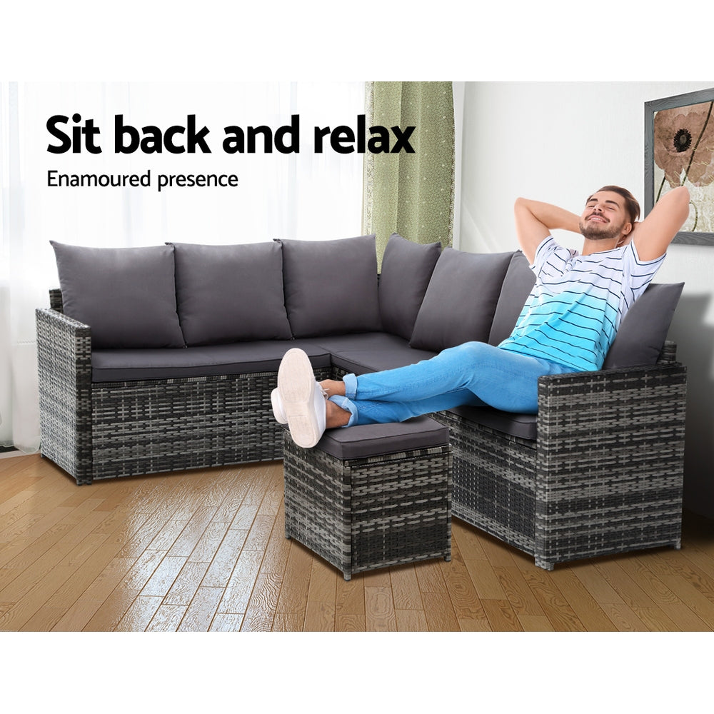 Outdoor wicker sectional sofa with dark gray cushions and matching corner ottoman
